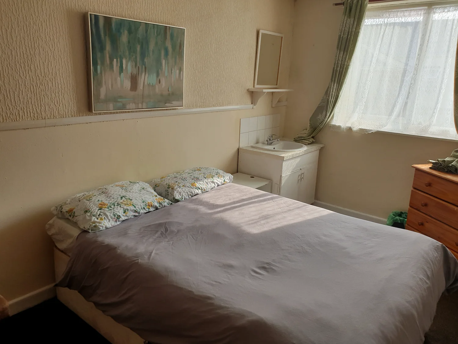 Larger guest bedroom with double bed, storage and natural light